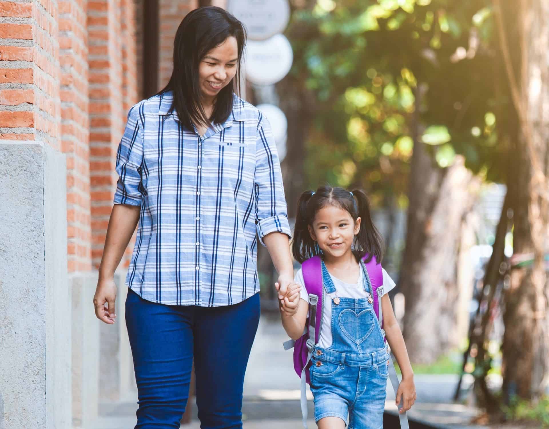 Young Asian Mother walks to school with daughter in Delaware